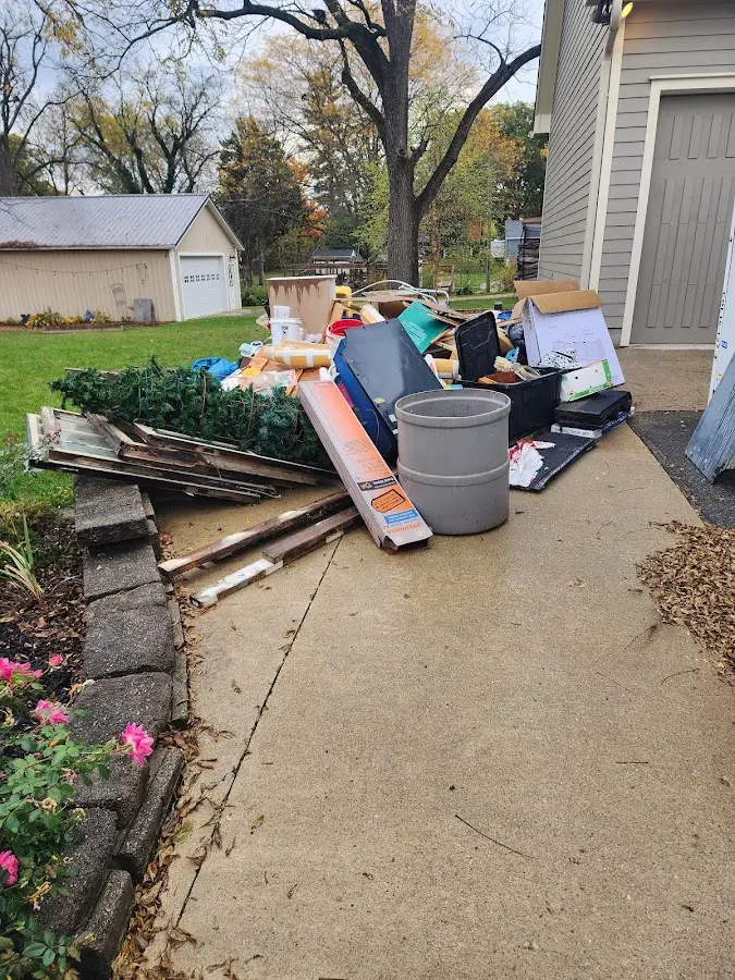 Dumpster being loaded with debris for 12 Yard Dumpster Rental in Lower Allen